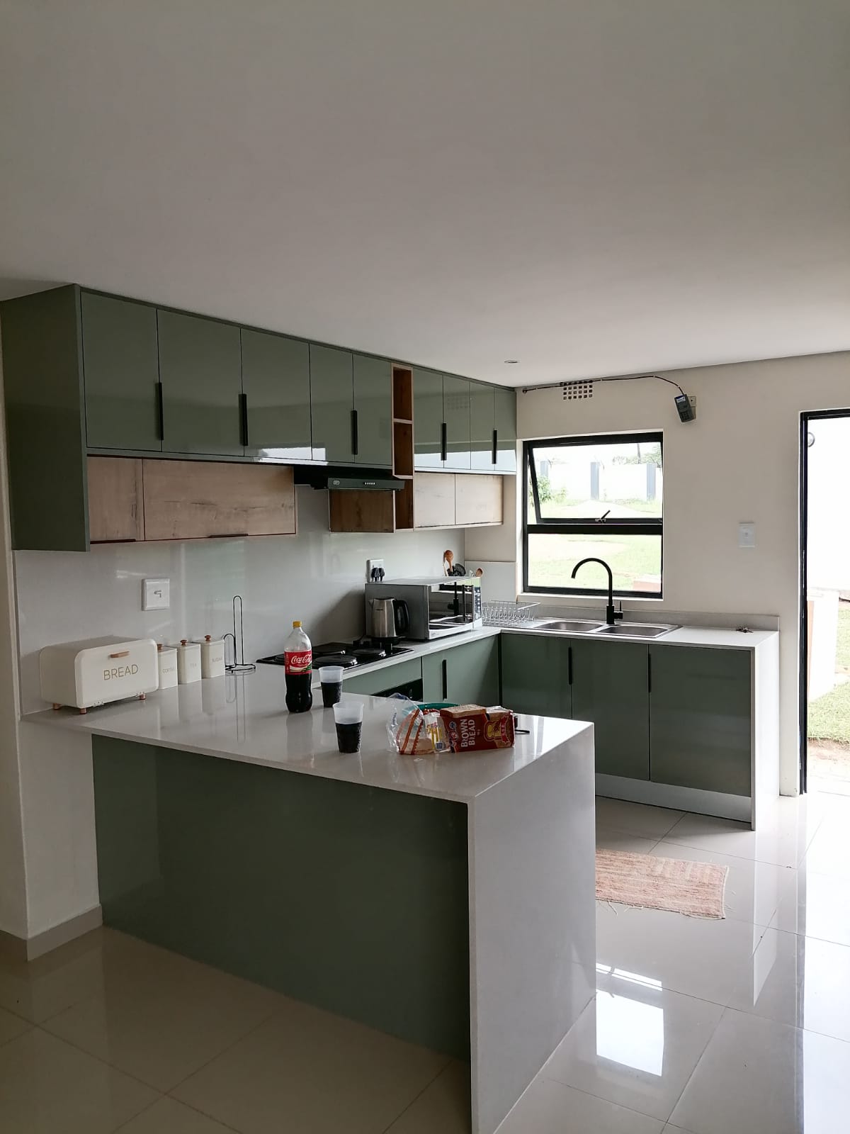 Sage green U-shape kitchen